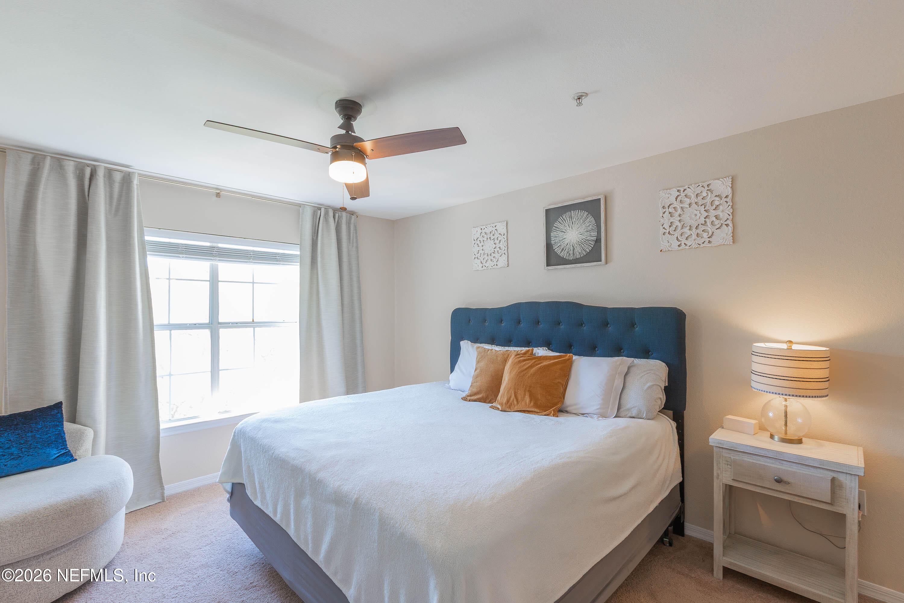 10961 Burnt Mill Road, Unit 734 Jacksonville, FL 32256 - Photo 18 of 35 a bedroom with a bed and a couch