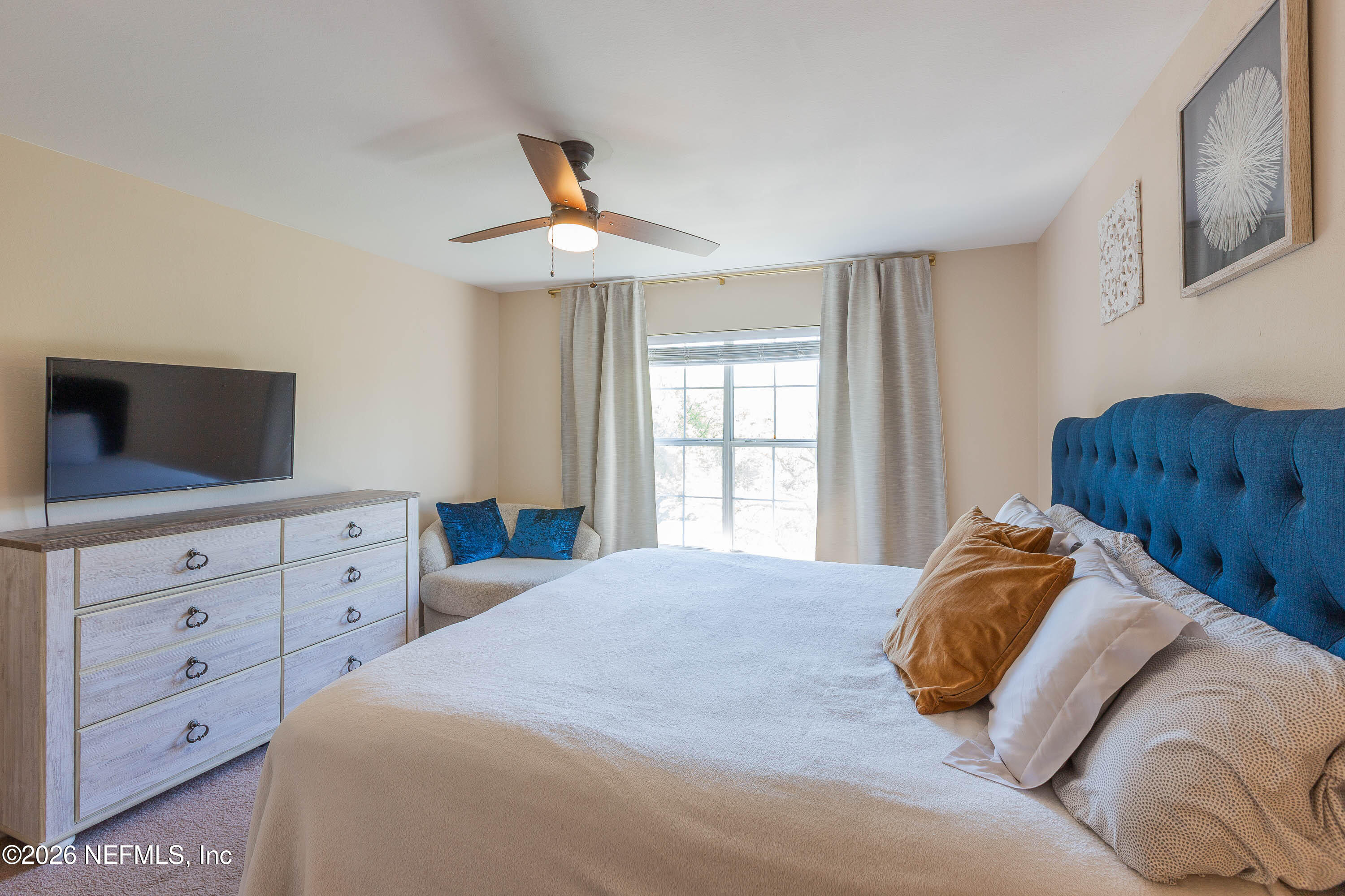 10961 Burnt Mill Road, Unit 734 Jacksonville, FL 32256 - Photo 19 of 35 a bedroom with a large bed and a window