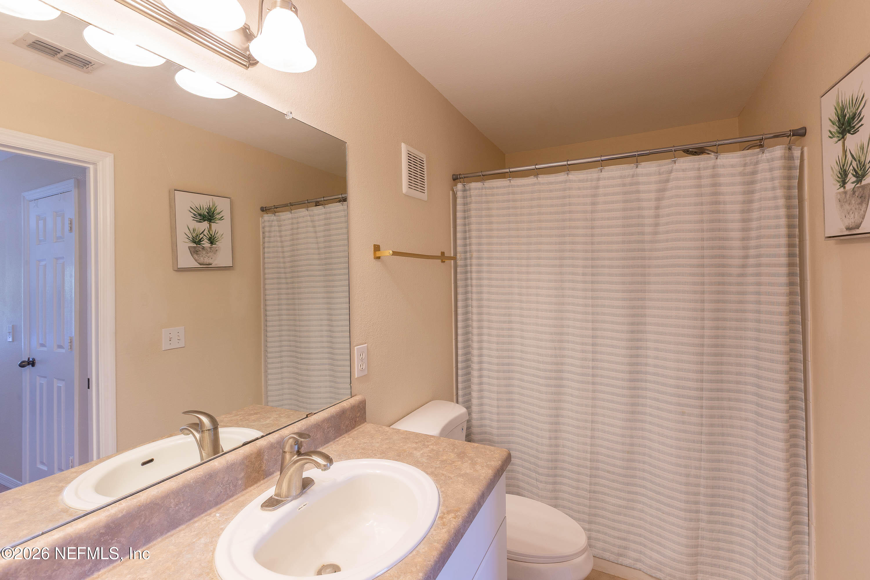 10961 Burnt Mill Road, Unit 734 Jacksonville, FL 32256 - Photo 20 of 35 a bathroom with a sink a toilet and mirror