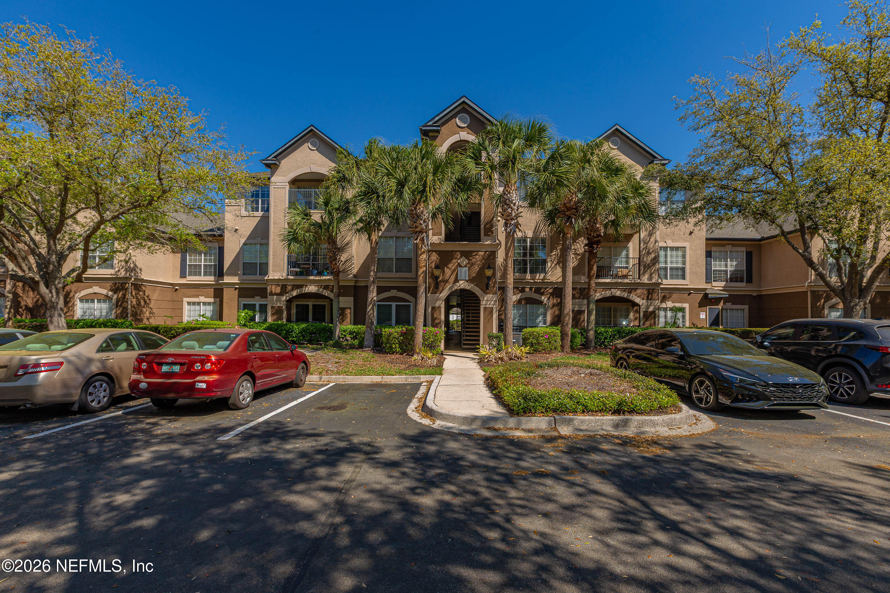 10961 Burnt Mill Road, Unit 734 Jacksonville, FL 32256 - Photo 2 of 35 a view of street with parked cars