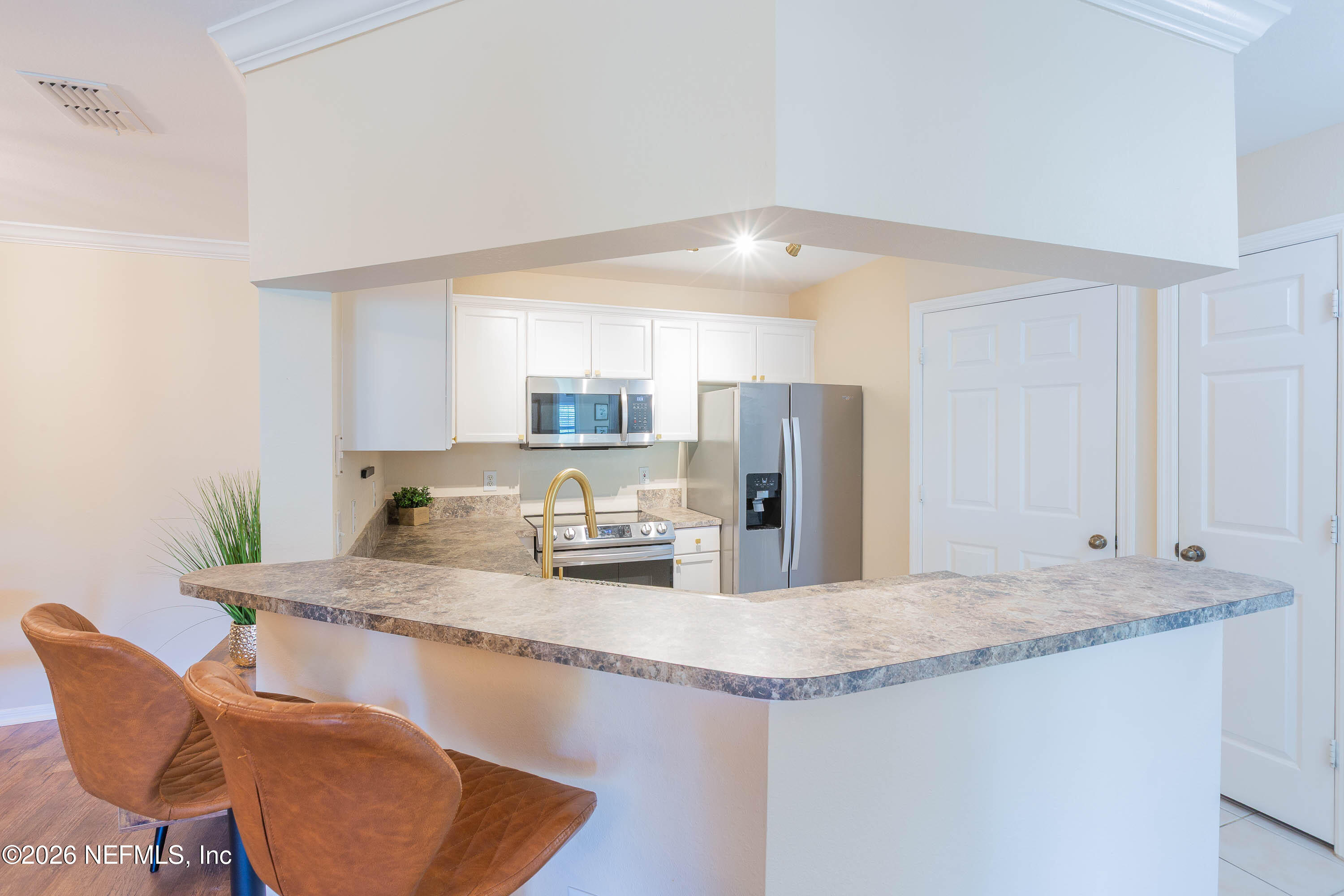 10961 Burnt Mill Road, Unit 734 Jacksonville, FL 32256 - Photo 8 of 35 a kitchen with stainless steel appliances granite countertop a sink refrigerator and cabinets