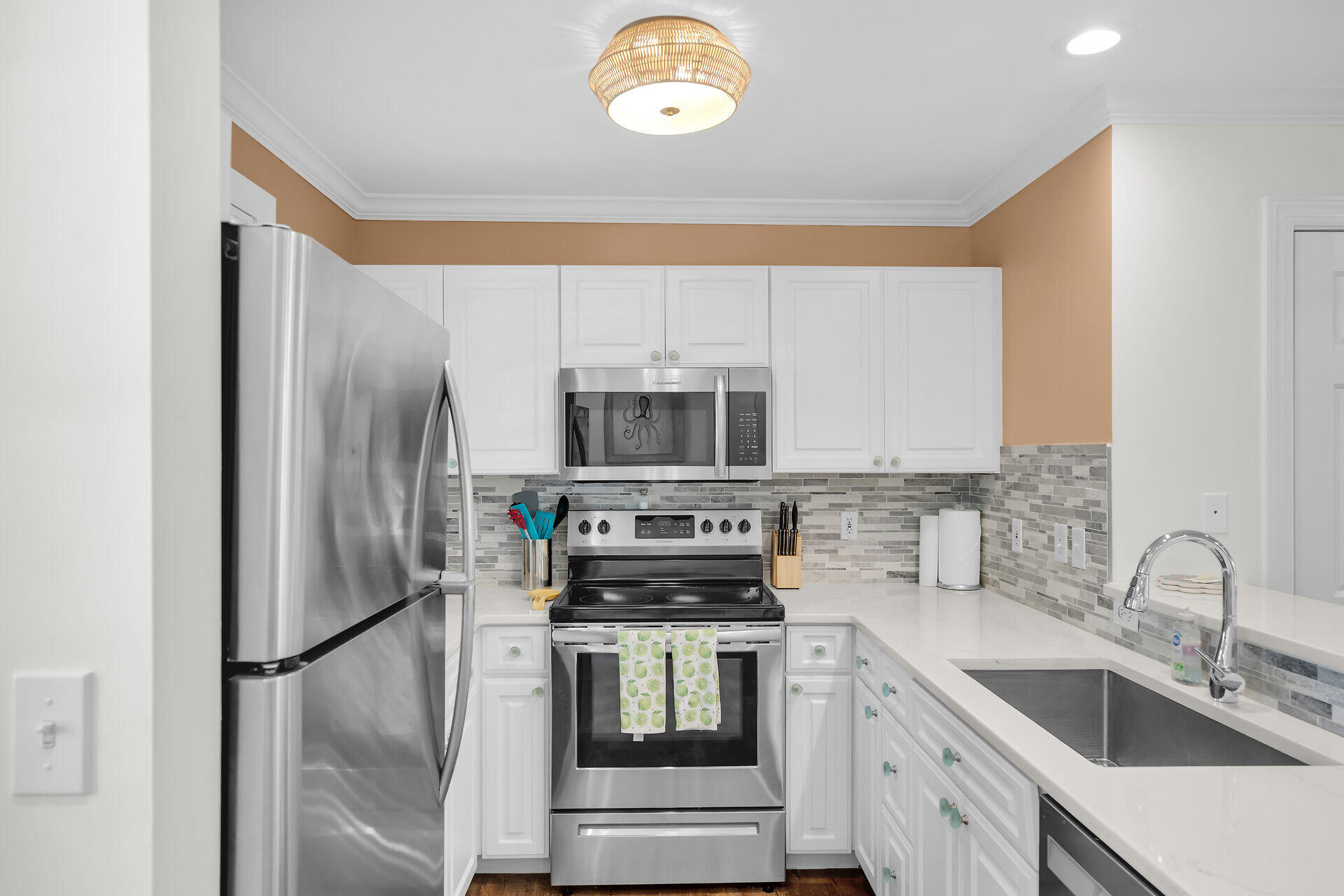 60 Golf Club Drive Key West, FL 33040 - Photo 11 of 42 a kitchen with stainless steel appliances granite countertop a refrigerator sink and stove