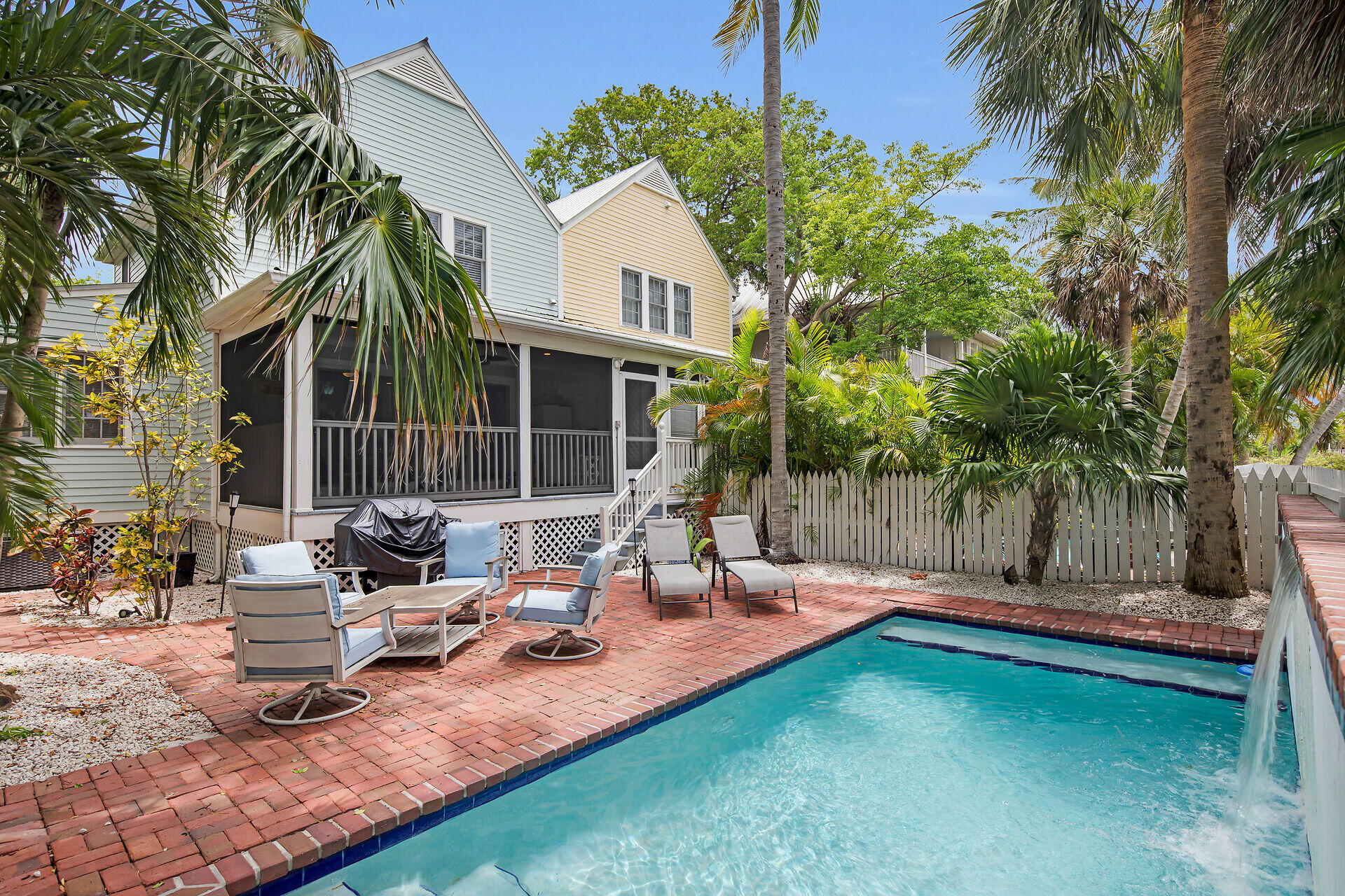 60 Golf Club Drive Key West, FL 33040 - Photo 3 of 42 a backyard of a house with fountain table and chairs