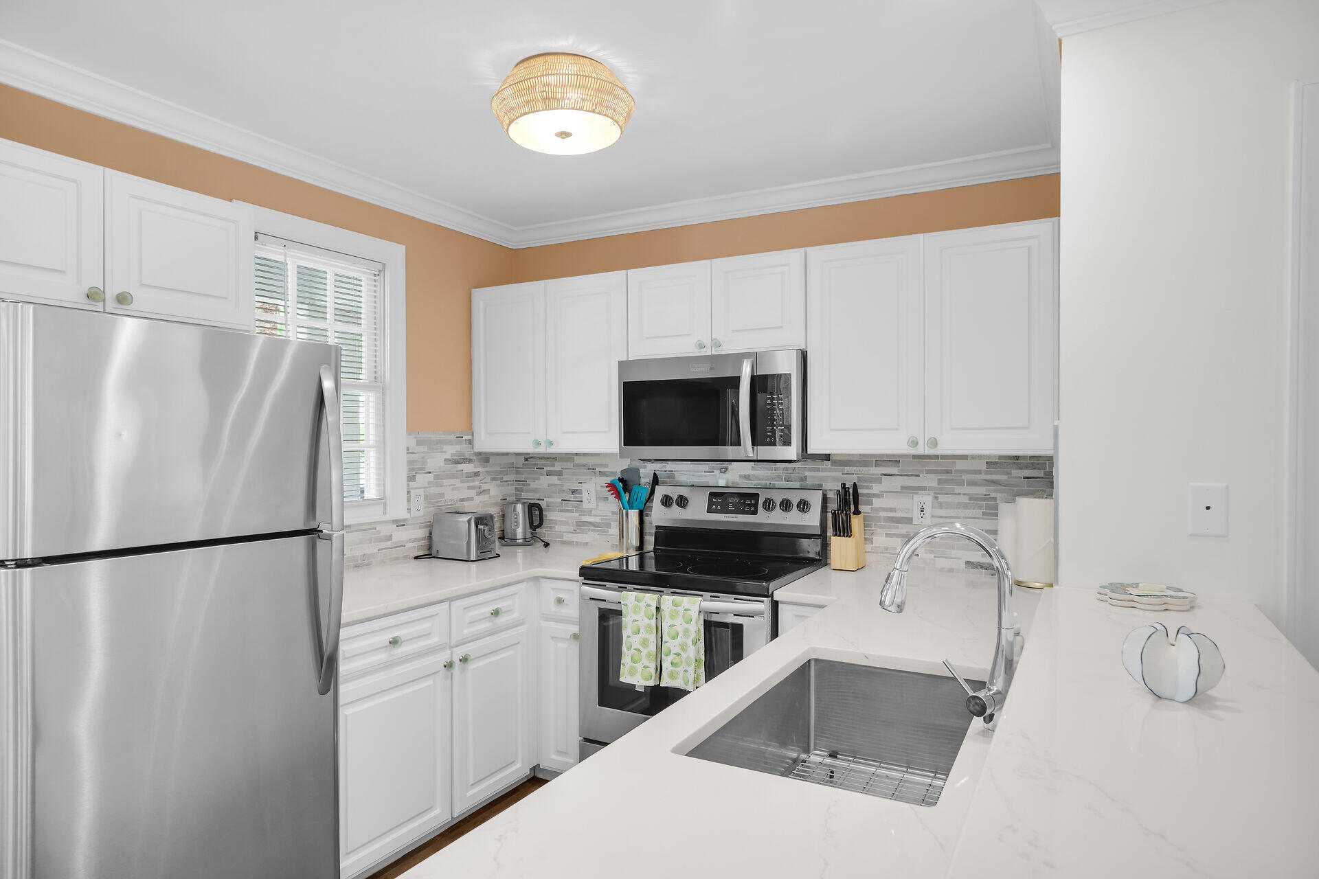 60 Golf Club Drive Key West, FL 33040 - Photo 10 of 42 a kitchen with stainless steel appliances a refrigerator sink and microwave