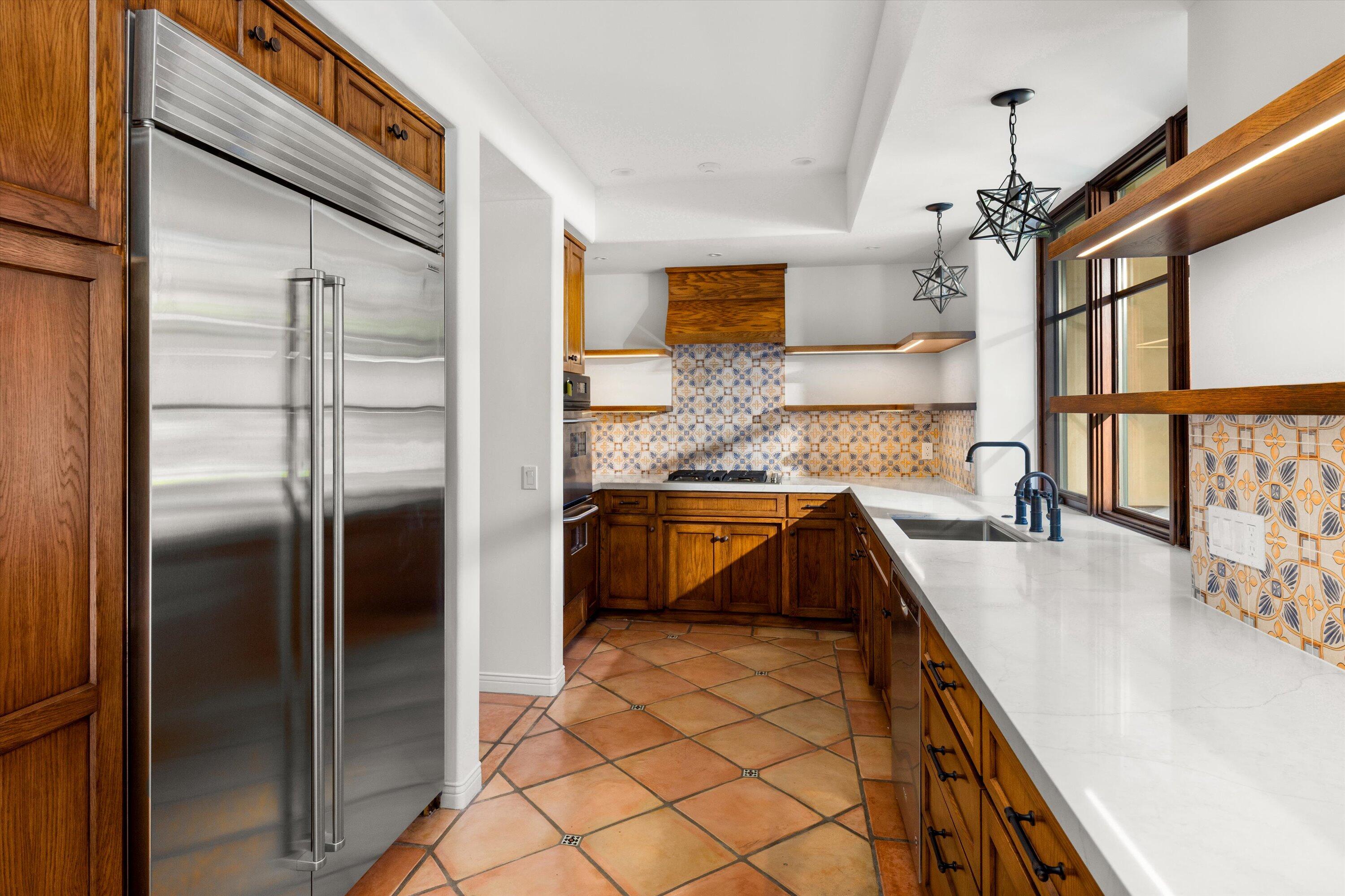 342 Sheffield Drive Montecito, CA 93108 - Photo 13 of 46 a kitchen with stainless steel appliances granite countertop a sink and a refrigerator