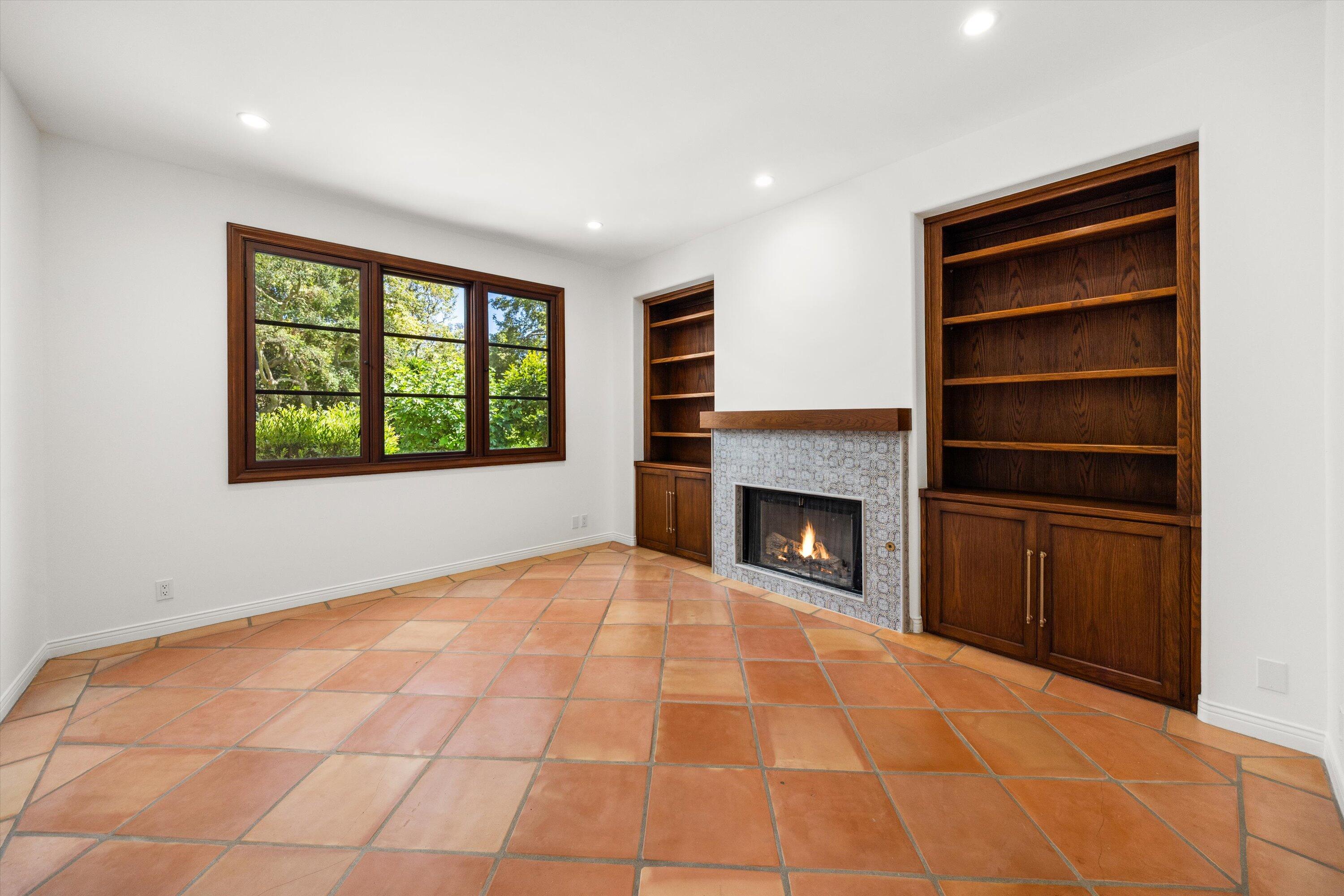 342 Sheffield Drive Montecito, CA 93108 - Photo 18 of 46 a view of an empty room with a fireplace and a window
