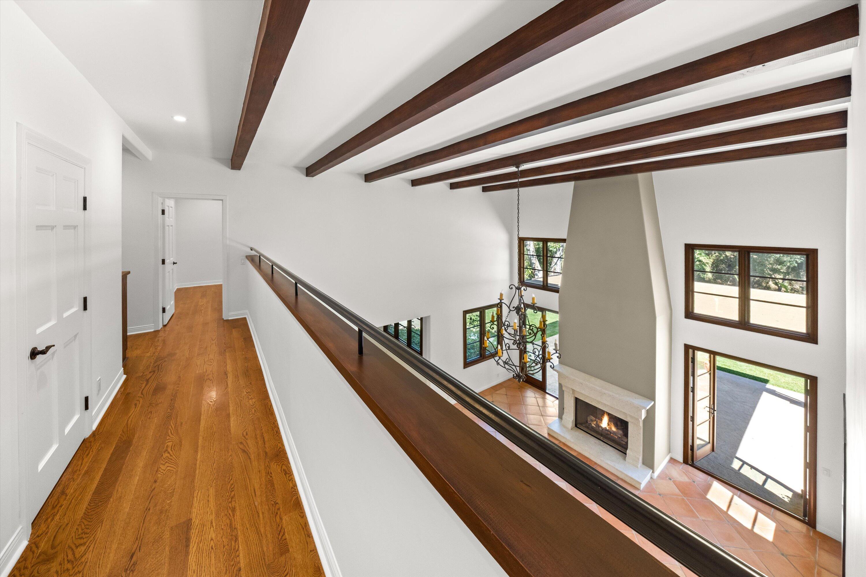342 Sheffield Drive Montecito, CA 93108 - Photo 23 of 46 a hallway with wooden floor and chandelier