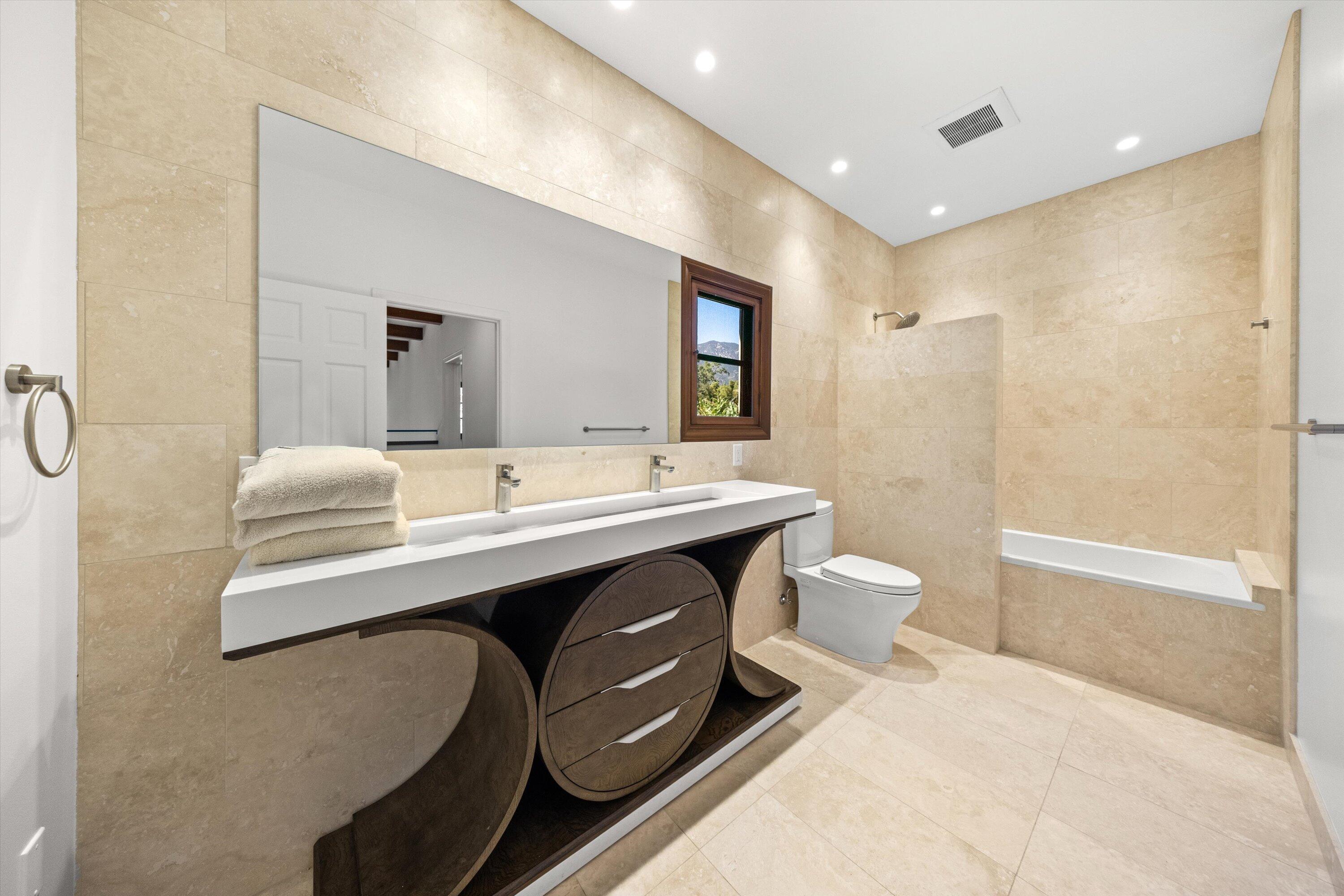 342 Sheffield Drive Montecito, CA 93108 - Photo 28 of 46 a bathroom with a double vanity sink toilet and shower