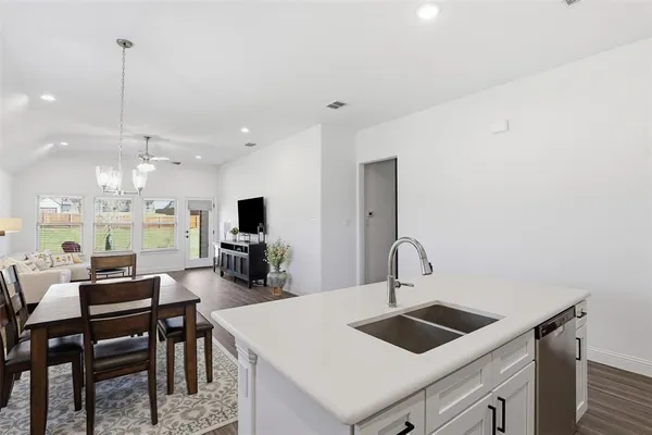 a kitchen with a sink a counter top space and appliances