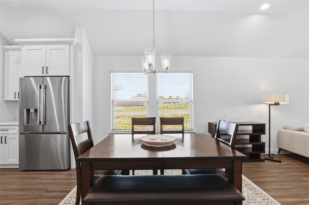 1101 Springfield Road Springtown, TX 76082 - Photo 13 of 32 a view of a dining room with furniture window and wooden floor