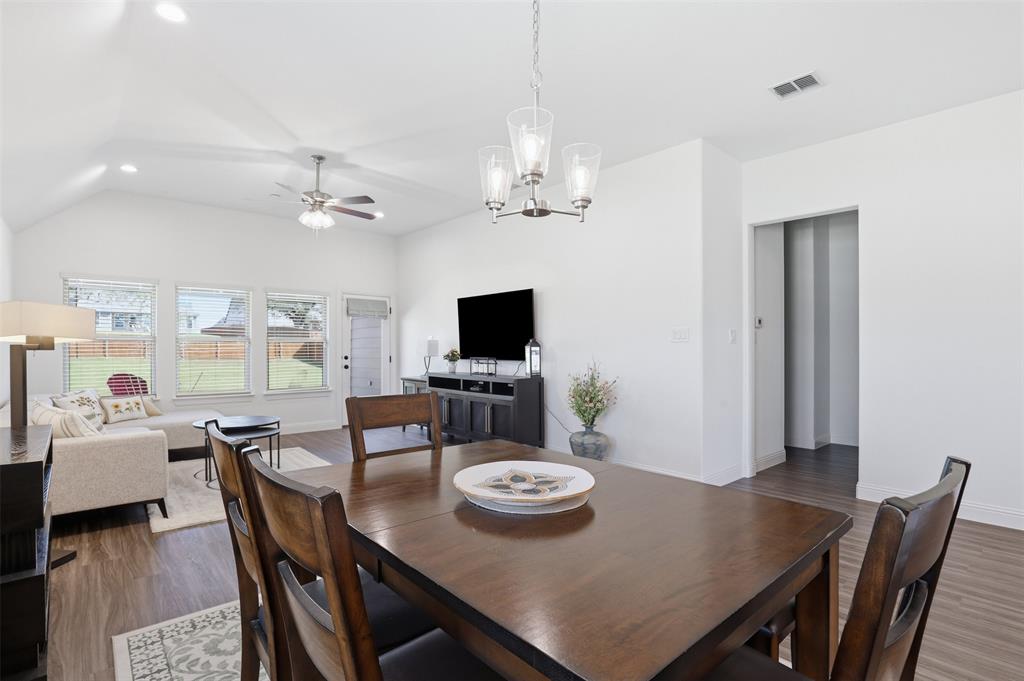1101 Springfield Road Springtown, TX 76082 - Photo 14 of 32 a view of a dining room with furniture a chandelier and wooden floor