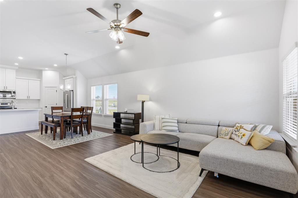 1101 Springfield Road Springtown, TX 76082 - Photo 15 of 32 a living room with furniture and a dining table with wooden floor