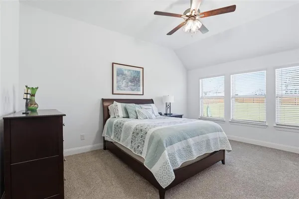 a bedroom with a bed lamp and window