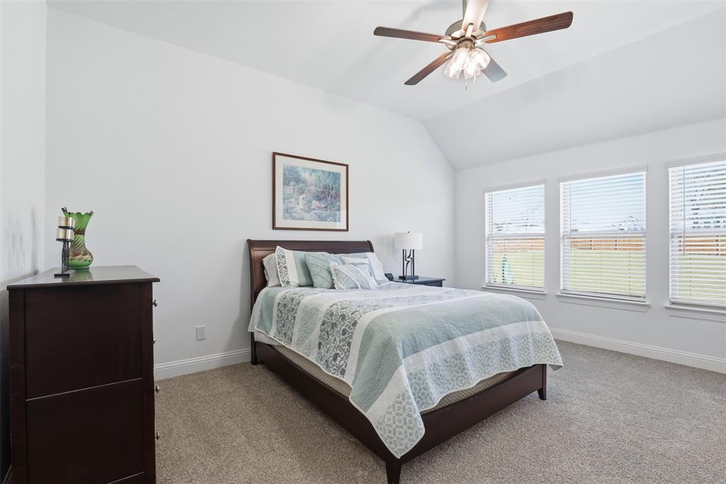 1101 Springfield Road Springtown, TX 76082 - Photo 23 of 32 a bedroom with a bed lamp and window