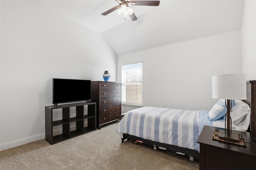 1101 Springfield Road Springtown, TX 76082 - Photo 27 of 32 a bedroom with a bed and a flat tv screen on the dresser