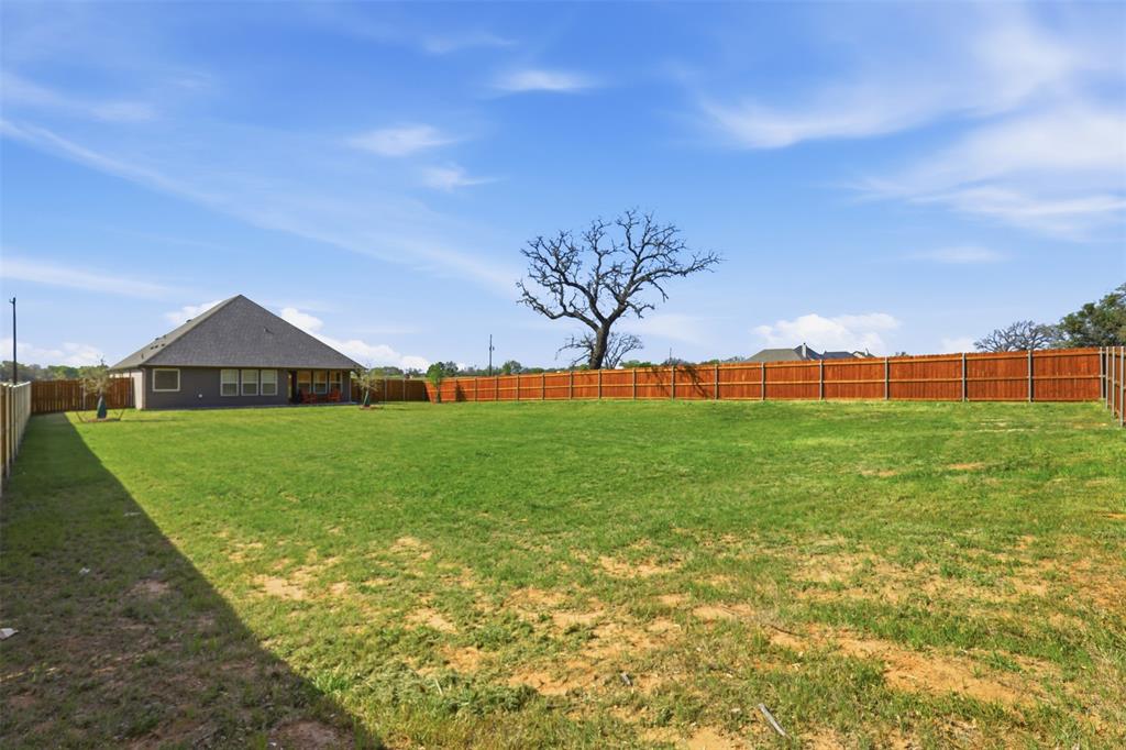1101 Springfield Road Springtown, TX 76082 - Photo 29 of 32 a view of green field with house in the background
