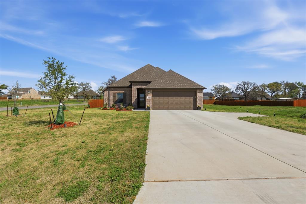 1101 Springfield Road Springtown, TX 76082 - Photo 4 of 32 a front view of a house with garden