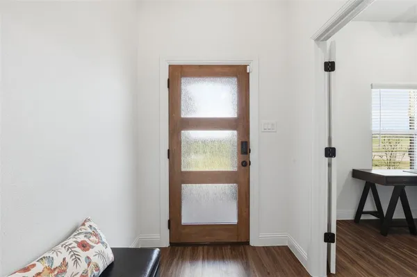 a view of room with window and wooden floor