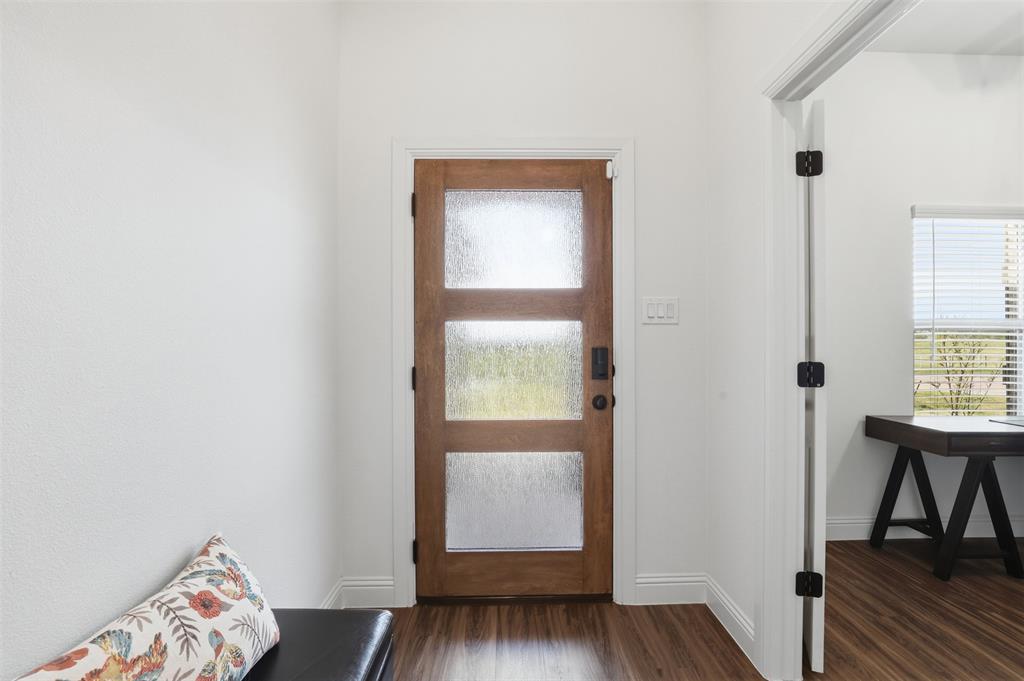 1101 Springfield Road Springtown, TX 76082 - Photo 7 of 32 a view of room with window and wooden floor