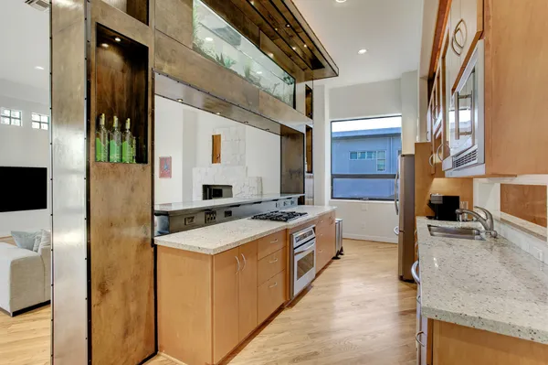 a kitchen with stainless steel appliances granite countertop a sink stove and refrigerator