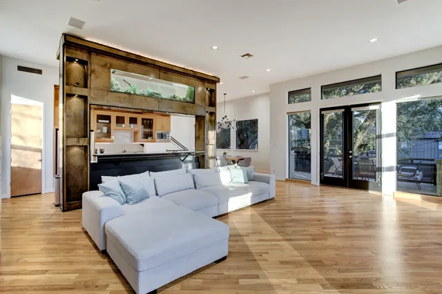 a living room with furniture and wooden floor