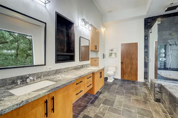 a bathroom with a granite countertop sink and a large mirror