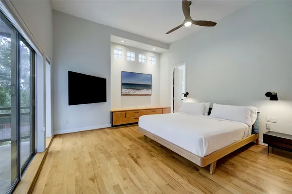 a bedroom with a bed and a flat screen tv