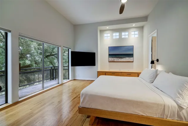 a bedroom with a bed and a large window