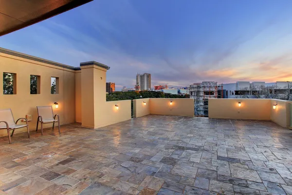 a view of a patio with a table and chairs