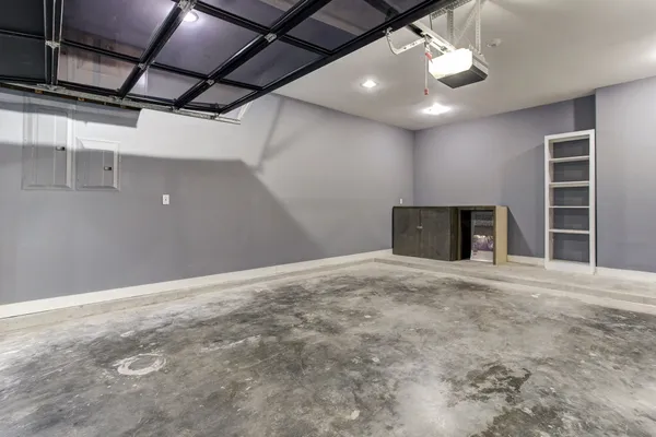 a view of an empty room with a fireplace and a window