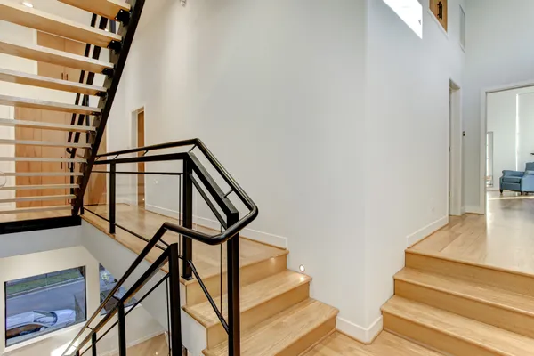 a view of entryway with wooden floor and stairs