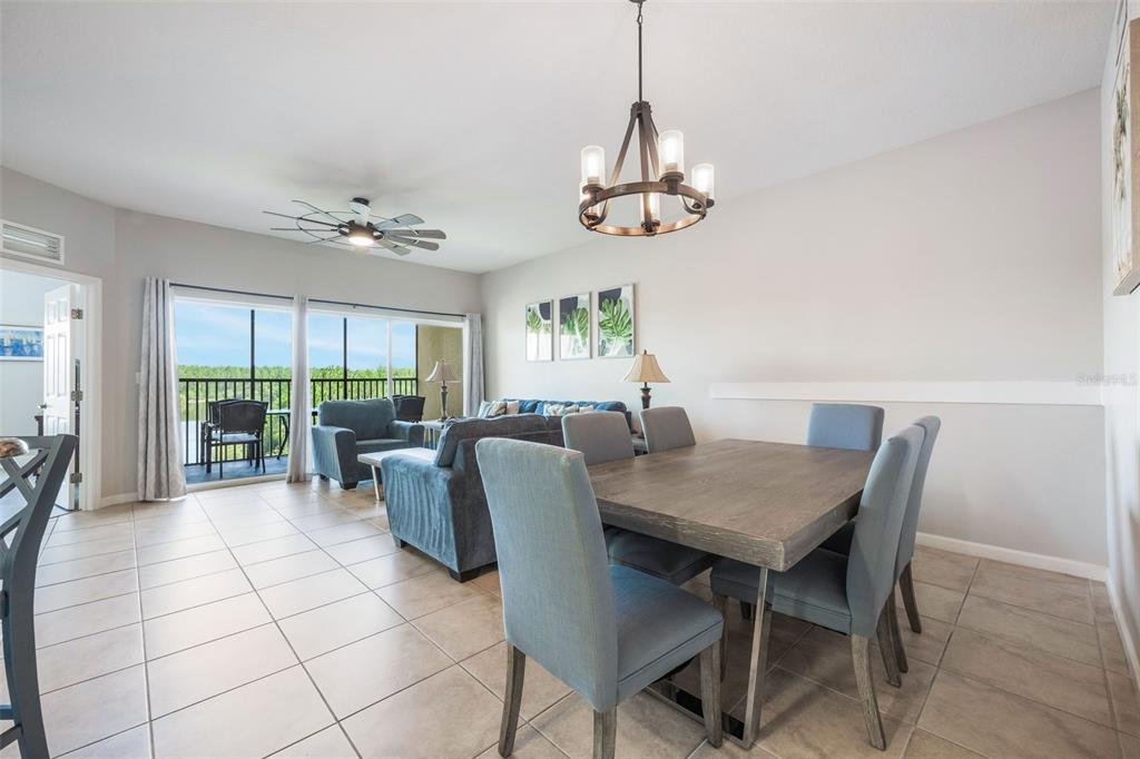 8774 Worldquest Boulevard, Unit 7404 Orlando, FL 32821 - Photo 11 of 55 a view of a dining room with furniture window and outside view