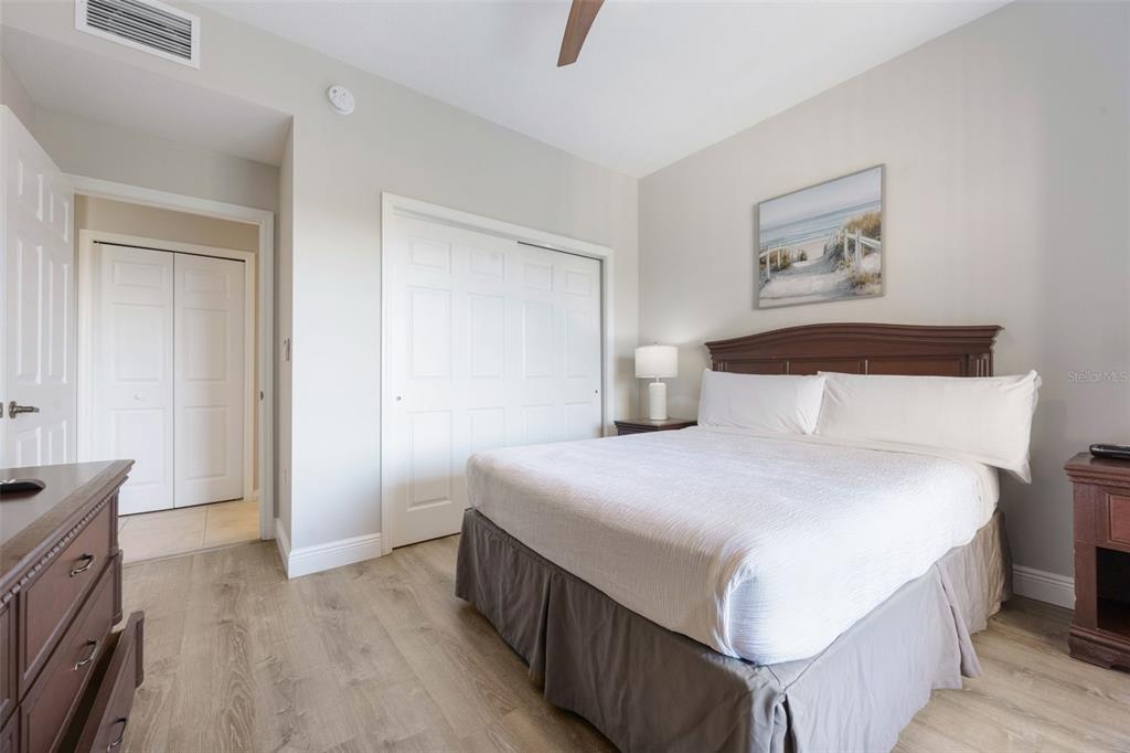 8774 Worldquest Boulevard, Unit 7404 Orlando, FL 32821 - Photo 16 of 55 a bedroom with a bed and a flat tv screen on dresser