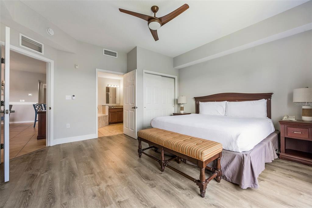 8774 Worldquest Boulevard, Unit 7404 Orlando, FL 32821 - Photo 20 of 55 a bedroom with a bed and wooden floor