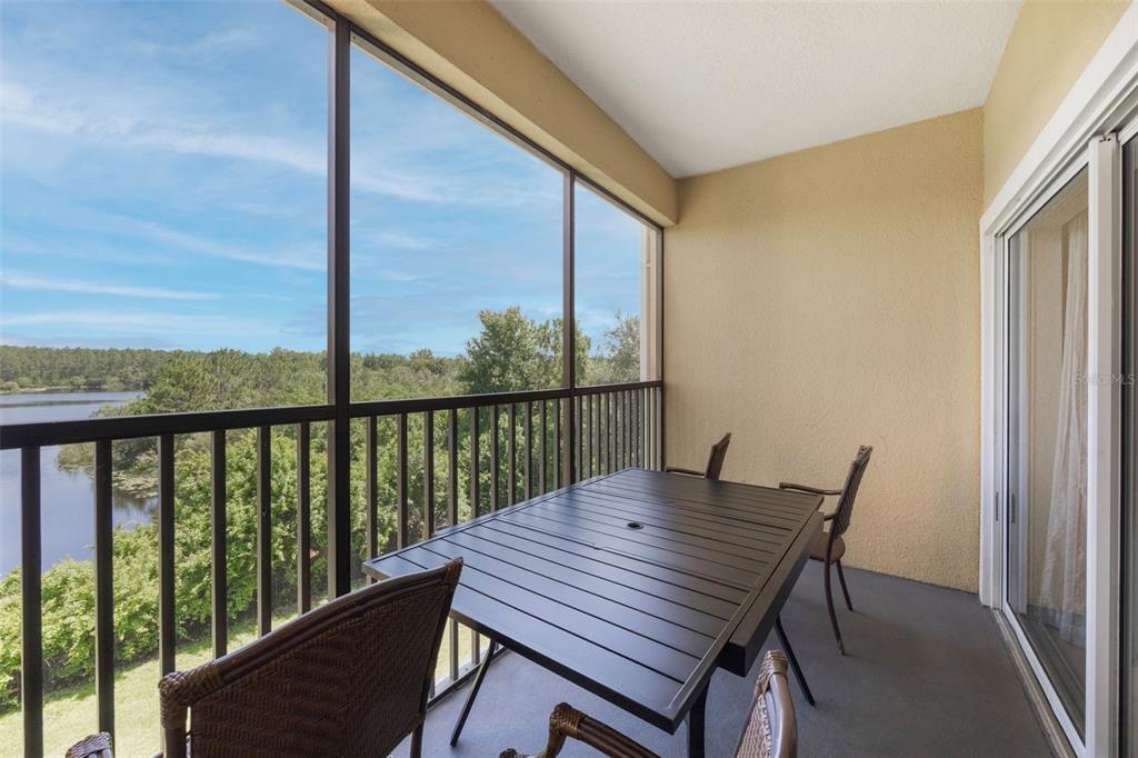 8774 Worldquest Boulevard, Unit 7404 Orlando, FL 32821 - Photo 27 of 55 a view of a balcony with a table and chairs