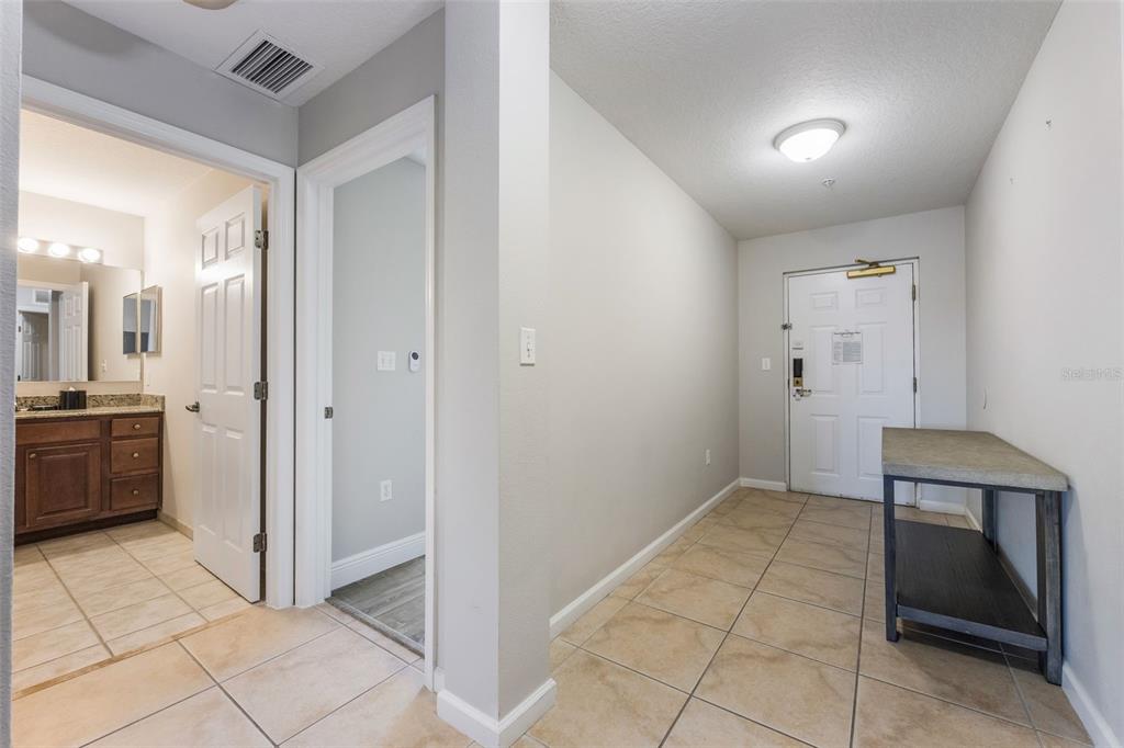 8774 Worldquest Boulevard, Unit 7404 Orlando, FL 32821 - Photo 4 of 55 a view of a hallway to rooms and stairs