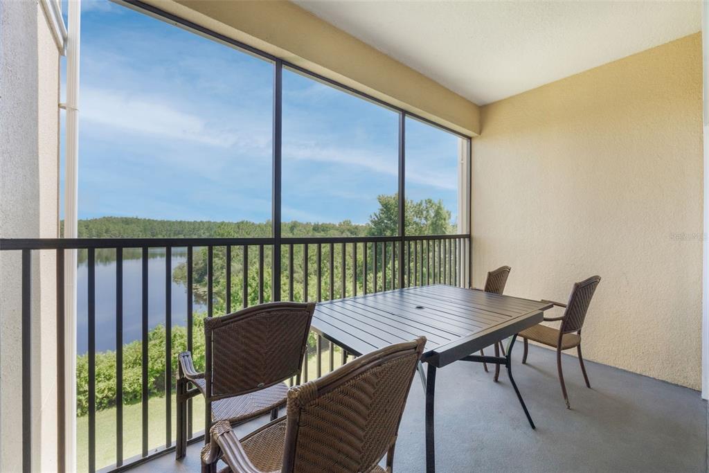 8774 Worldquest Boulevard, Unit 7404 Orlando, FL 32821 - Photo 48 of 55 a view of a balcony with a table and chairs