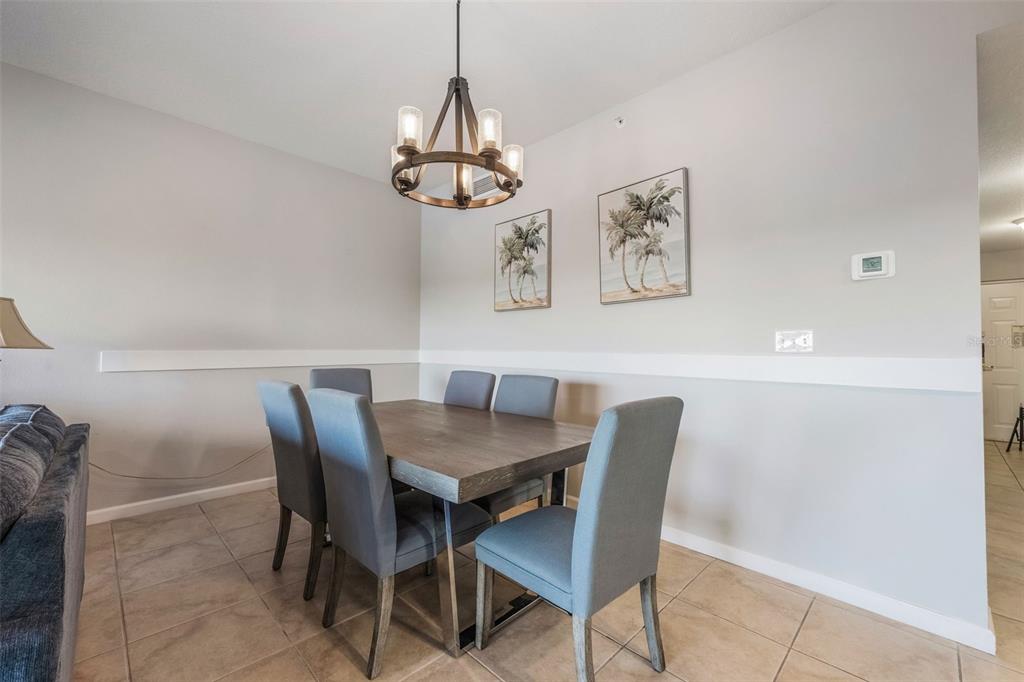 8774 Worldquest Boulevard, Unit 7404 Orlando, FL 32821 - Photo 10 of 55 a view of a dining room with furniture