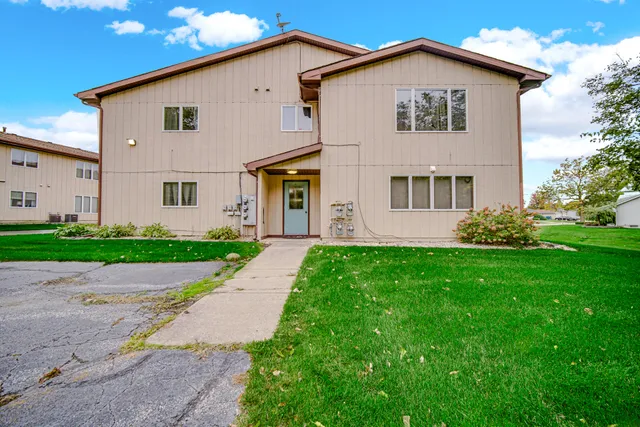 a view of a yard in front view of a house