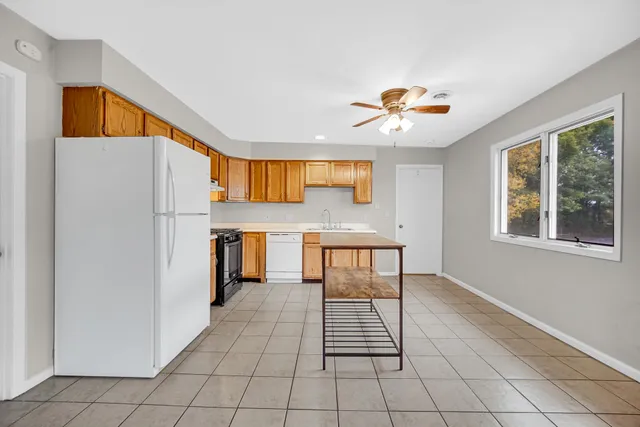 a kitchen with stainless steel appliances granite countertop a refrigerator and a stove top oven