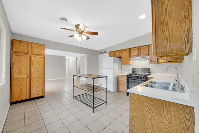 a kitchen with a sink cabinets and appliances