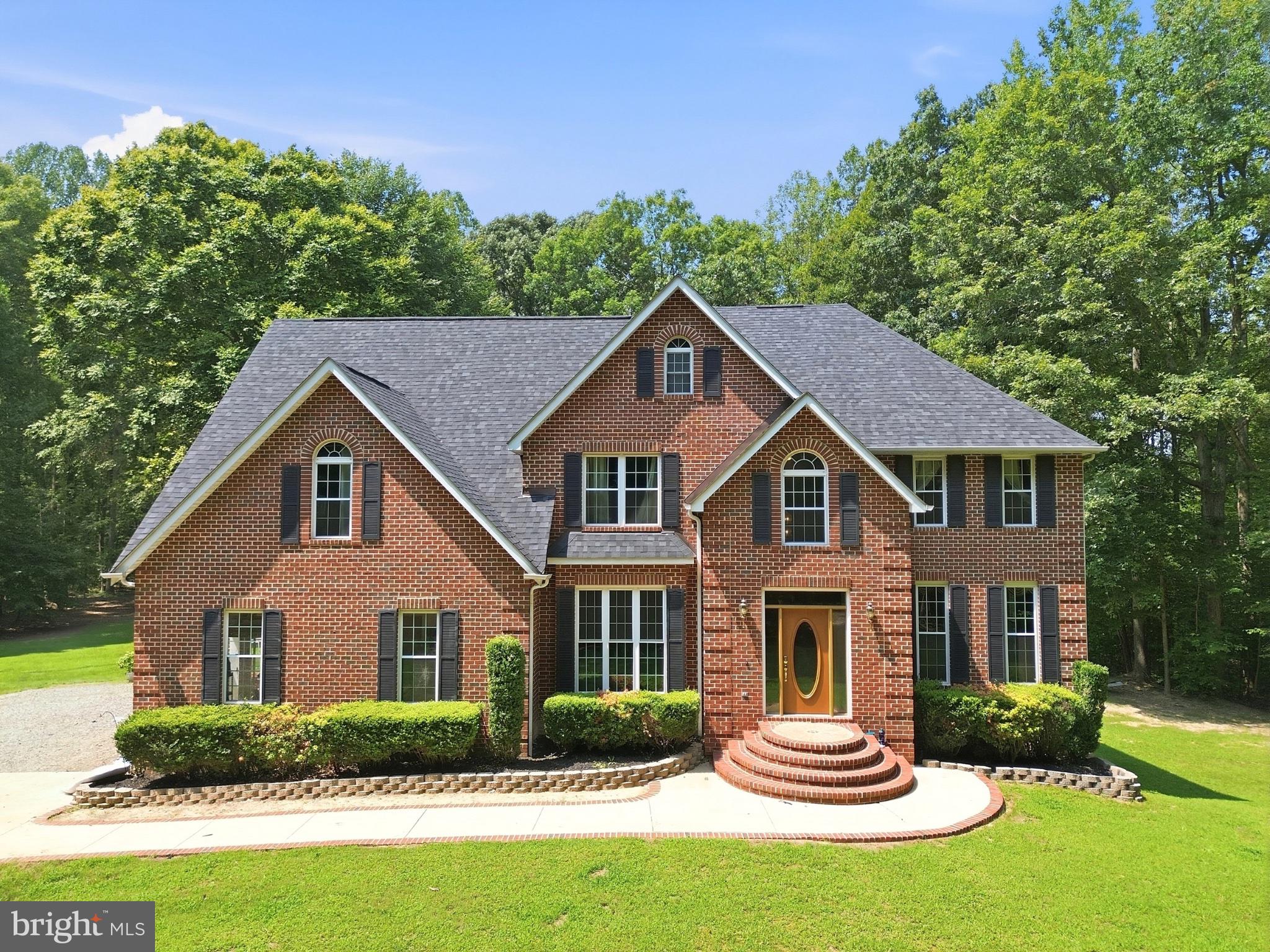Charming brick home in lush surroundings.