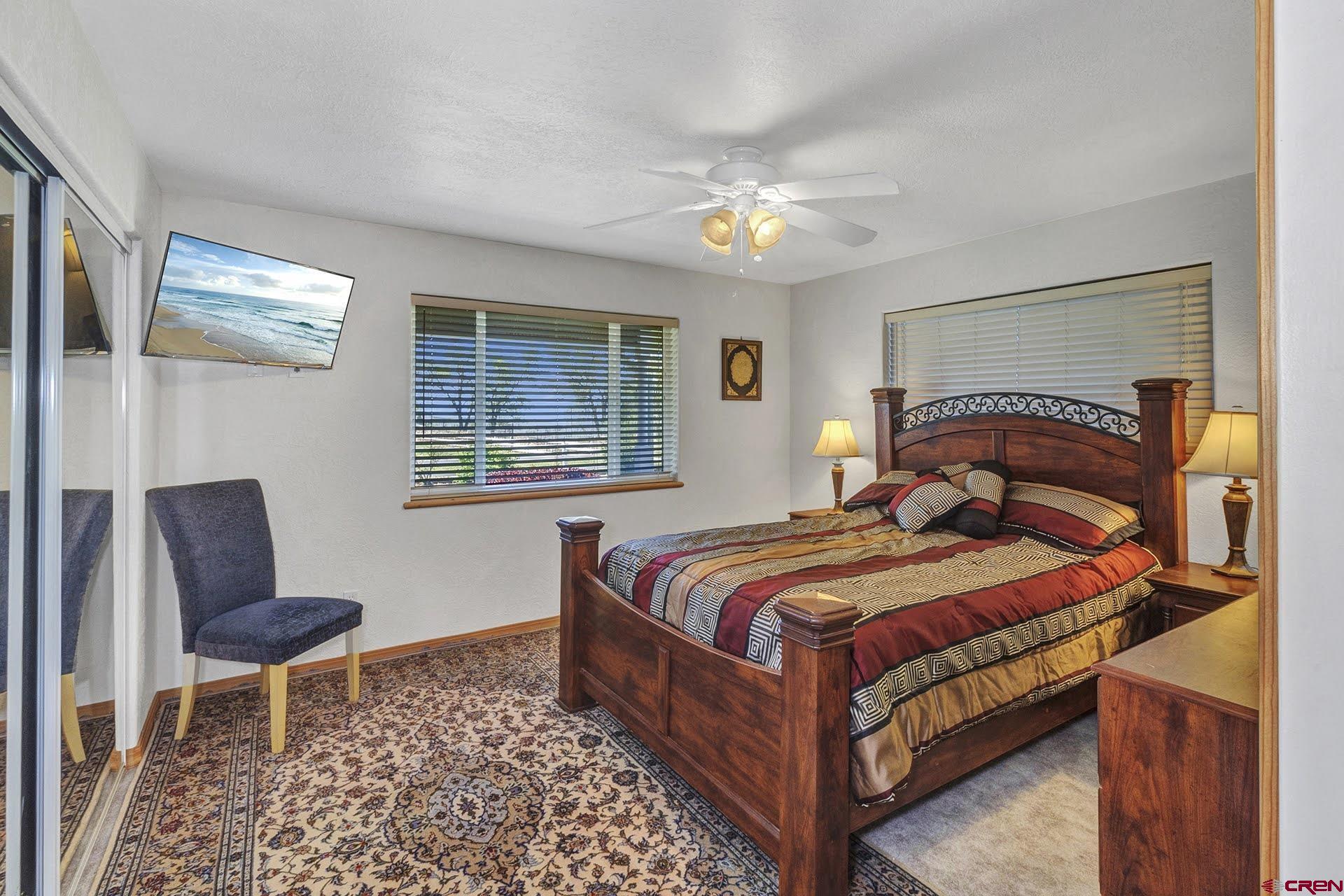 1036 East Main Street Cedaredge, CO 81413 - Photo 20 of 36 a bedroom with a bed and chair