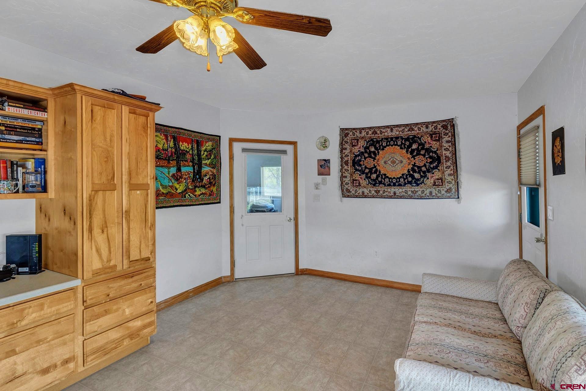 1036 East Main Street Cedaredge, CO 81413 - Photo 23 of 36 a living room with furniture and a flat screen tv