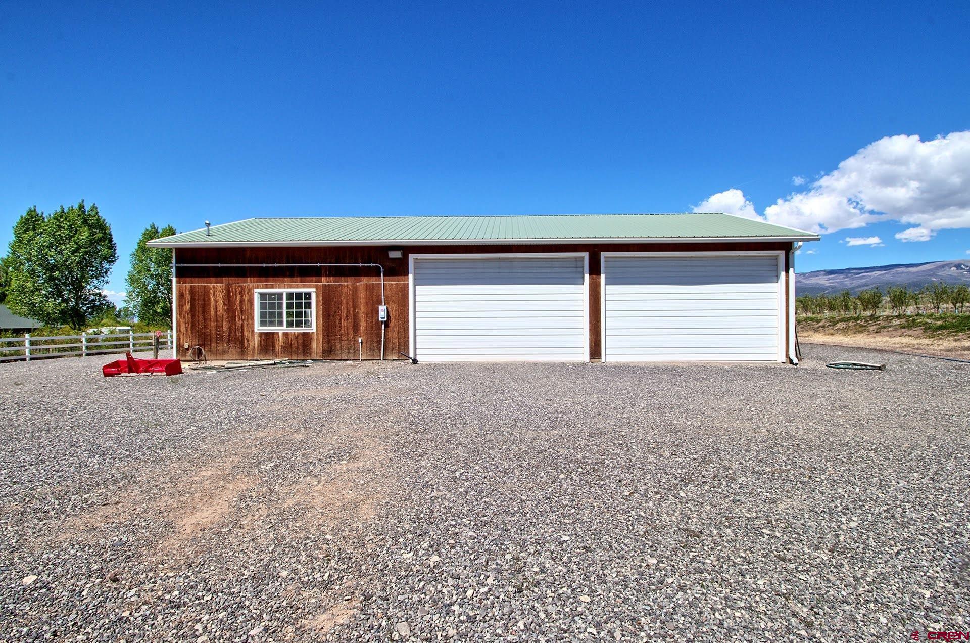 1036 East Main Street Cedaredge, CO 81413 - Photo 30 of 36 a view of a house with a yard and garage