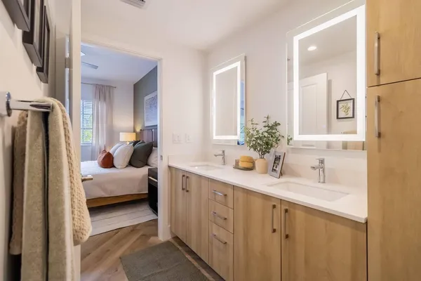 a en suite bathroom with a double sink and mirror