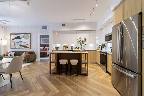 a kitchen with stainless steel appliances kitchen island granite countertop a refrigerator and a stove