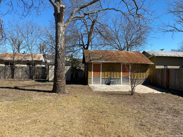 a view of a house with backyard and sitting area