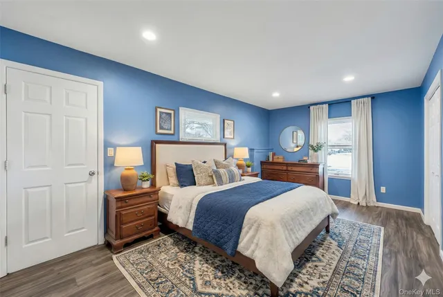 a bedroom with a large bed and a chandelier
