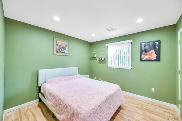 a bedroom with a bed and a painting on the wall